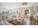 Open-concept living space with a comfortable sofa, natural light, and seamless flow to the dining area at 229 S Harbor Dr, Holmes Beach, FL 34217