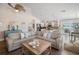 Spacious living area with ample seating, hardwood floors, and seamless connection to the kitchen at 229 S Harbor Dr, Holmes Beach, FL 34217