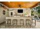 Inviting outdoor bar area with a flat-screen TV, marine-themed decor, and comfortable seating at 229 S Harbor Dr, Holmes Beach, FL 34217