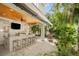 Stylish outdoor bar with a TV, seating, and tropical decor, perfect for entertaining by the pool at 229 S Harbor Dr, Holmes Beach, FL 34217