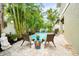 Serene patio space with woven chairs, a decorative table, and views of the lush pool area at 229 S Harbor Dr, Holmes Beach, FL 34217
