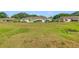 Exterior of home with a backyard of sprawling lawn space at 2607 Lancaster Dr # 35, Sun City Center, FL 33573