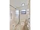 Bathroom featuring a shower, toilet, cabinet, and other fixtures with a bright overhead light at 2607 Lancaster Dr # 35, Sun City Center, FL 33573