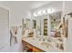 A bathroom vanity with sink, mirror, towel rack, and a view of the shower in the mirror at 2607 Lancaster Dr # 35, Sun City Center, FL 33573