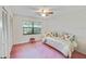 Well-lit bedroom featuring large window, spacious closet, and decorative floral bedding at 2607 Lancaster Dr # 35, Sun City Center, FL 33573