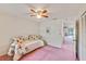 Bedroom with a bed with floral print linens, a ceiling fan, and access to a hallway at 2607 Lancaster Dr # 35, Sun City Center, FL 33573