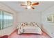 Bright bedroom features a ceiling fan and a quaint white metal bed frame at 2607 Lancaster Dr # 35, Sun City Center, FL 33573