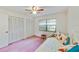 Comfortable bedroom with closet space, fan, and a large window at 2607 Lancaster Dr # 35, Sun City Center, FL 33573