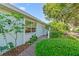 Close-up of a light blue home with brick walkway and lush green bushes at 2607 Lancaster Dr # 35, Sun City Center, FL 33573