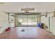 Bright garage featuring an automatic garage door, painted floor, and storage for garbage and recycling at 2607 Lancaster Dr # 35, Sun City Center, FL 33573