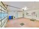 A spacious garage featuring white walls, painted floor, a water heater, and built-in storage cabinets at 2607 Lancaster Dr # 35, Sun City Center, FL 33573