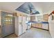 Bright kitchen featuring light wood cabinetry, patterned flooring, and modern appliances at 2607 Lancaster Dr # 35, Sun City Center, FL 33573