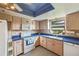 Cozy kitchen with wooden cabinets, blue countertops, and a stylish patterned floor at 2607 Lancaster Dr # 35, Sun City Center, FL 33573