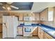 Kitchen with cabinets, mosaic backsplash, and appliances, accented by a decorative ceiling at 2607 Lancaster Dr # 35, Sun City Center, FL 33573