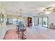 Bright living room featuring a ceiling fan, decorative lighting, and an adjacent bar area at 2607 Lancaster Dr # 35, Sun City Center, FL 33573