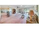 Spacious living area featuring an open floor plan, bar seating, and a sunroom at 2607 Lancaster Dr # 35, Sun City Center, FL 33573