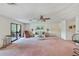 Inviting living room with comfortable seating, a ceiling fan, and an adjacent sunroom at 2607 Lancaster Dr # 35, Sun City Center, FL 33573