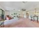 Open living room with a ceiling fan, bar seating, and sliding glass doors leading to an outdoor space at 2607 Lancaster Dr # 35, Sun City Center, FL 33573