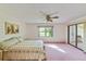 Main bedroom featuring a ceiling fan, a view of the lawn, and a sunroom at 2607 Lancaster Dr # 35, Sun City Center, FL 33573
