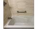 Relaxing bathroom with a soaking tub and tiled walls at 2616 Hidden Lake N Dr # A, Sarasota, FL 34237