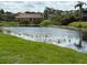Peaceful pond reflecting surrounding buildings, providing a serene and picturesque atmosphere for the community at 2616 Hidden Lake N Dr # A, Sarasota, FL 34237