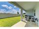 Covered patio and lush backyard with privacy fence at 2926 61St E Dr, Ellenton, FL 34222