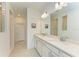 Bright bathroom features double vanity with quartz countertops and framed mirrors at 2926 61St E Dr, Ellenton, FL 34222