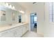Bright bathroom features double vanity with quartz countertops and framed mirrors at 2926 61St E Dr, Ellenton, FL 34222