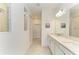 Bright bathroom features double vanity with quartz countertops and framed mirrors at 2926 61St E Dr, Ellenton, FL 34222