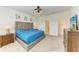 Spacious bedroom with soft carpet, a tufted headboard, and ensuite bathroom at 2926 61St E Dr, Ellenton, FL 34222