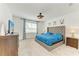 Comfortable bedroom featuring a king-sized bed, soft carpet, and large windows for natural light at 2926 61St E Dr, Ellenton, FL 34222