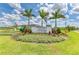 Entrance to the 'Marwood' community with lush landscaping, a manicured lawn, and clear blue skies at 2926 61St E Dr, Ellenton, FL 34222