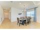 Bright dining room area featuring a modern chandelier and large window with natural light at 2926 61St E Dr, Ellenton, FL 34222