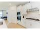 This modern kitchen features sleek white cabinets, stainless steel appliances, and a stylish backsplash at 2926 61St E Dr, Ellenton, FL 34222
