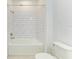 White tiled bathtub and shower with chrome fixtures at 2926 61St E Dr, Ellenton, FL 34222