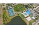 Aerial view showcases the community amenities: pools, tennis courts, playground, and a scenic pond at 315 Heritage Isles Way, Bradenton, FL 34212