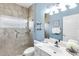 Bathroom featuring a glass enclosed shower, single sink vanity, light-blue walls, and decorative accents at 315 Heritage Isles Way, Bradenton, FL 34212