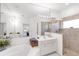 Bathroom featuring an oversized mirror, double sinks, a soaking tub, and a glass-enclosed shower at 315 Heritage Isles Way, Bradenton, FL 34212