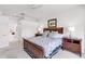 Bedroom featuring a wood-trimmed bed, neutral walls, and a glimpse into the adjacent bathroom at 315 Heritage Isles Way, Bradenton, FL 34212