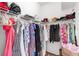 Walk-in closet with shelving and hanging rods filled with a variety of clothing and accessories at 315 Heritage Isles Way, Bradenton, FL 34212