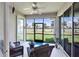 Relaxing lanai with comfortable seating and serene golf course views through the screened windows at 315 Heritage Isles Way, Bradenton, FL 34212