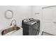Laundry room featuring a utility sink, modern washer and dryer, and a white door at 315 Heritage Isles Way, Bradenton, FL 34212