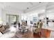 Open concept living area with hardwood floors, modern furniture, and views of the kitchen and patio at 315 Heritage Isles Way, Bradenton, FL 34212