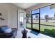 Screened patio featuring outdoor seating and a view of the lush green lawn with palm trees at 315 Heritage Isles Way, Bradenton, FL 34212
