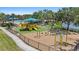 Community playground with colorful equipment, swings, slide, and a soft landing surface for  at 315 Heritage Isles Way, Bradenton, FL 34212
