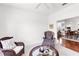 Bright sitting room with comfortable wicker chairs, plush armchairs, and a view into the dining area at 315 Heritage Isles Way, Bradenton, FL 34212