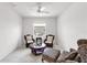 Cozy sitting room featuring comfortable seating, a ceiling fan and natural light from the window at 315 Heritage Isles Way, Bradenton, FL 34212