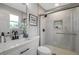 Modern bathroom features a tiled shower with glass door, updated vanity, and a sleek design at 3193 Bellevue St, Sarasota, FL 34237