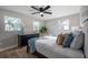 Cozy bedroom boasts natural light and stylish decor, complemented by a modern dresser at 3193 Bellevue St, Sarasota, FL 34237