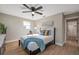 A comfy bedroom featuring neutral walls, tray on bed, and light-filled ensuite bathroom entrance at 3193 Bellevue St, Sarasota, FL 34237